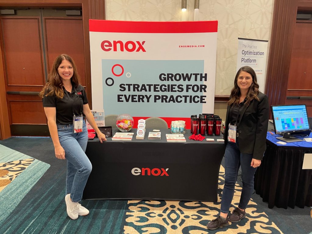 eNox Media table at Orthodontist conference, SAO, Sales and marketing representatives at booth with branded gifts and banner