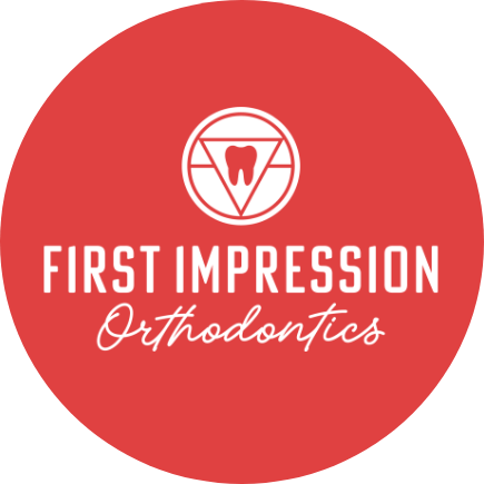eNox Media logo: circular design featuring a tooth and "First Impression Orthodontics" branding.